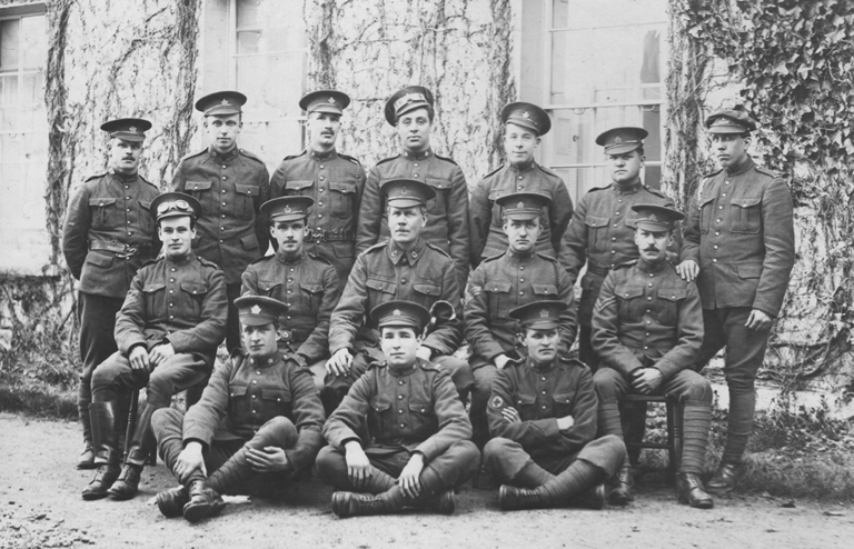 Soldiers in uniform pose for a group portrait 