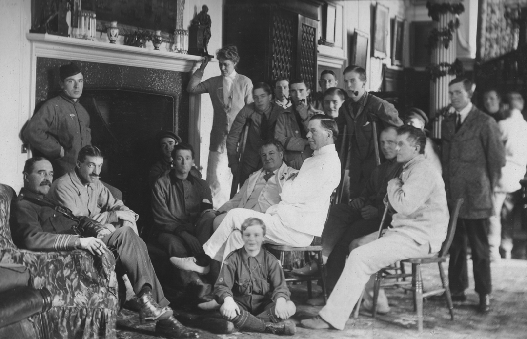 Doctors and soldiers relax near a fireplace